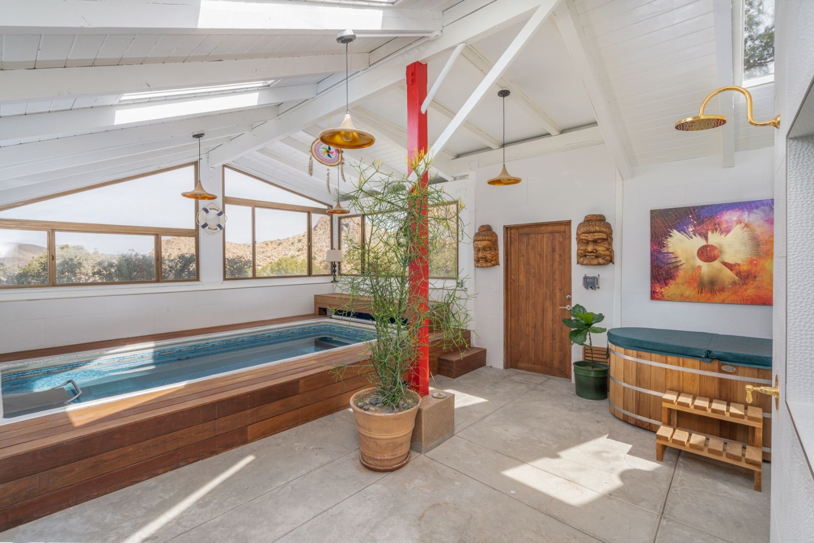 The endless pool room in the Spa at ESCAPE — vaulted ceiling, skylights, mountain view
