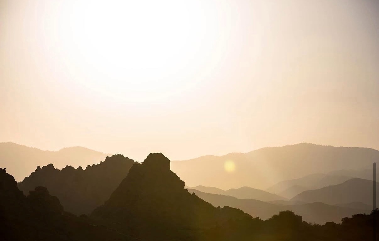 Sunset over the Pioneertown mountains at ESCAPE — golden-hour light across the high desert in California