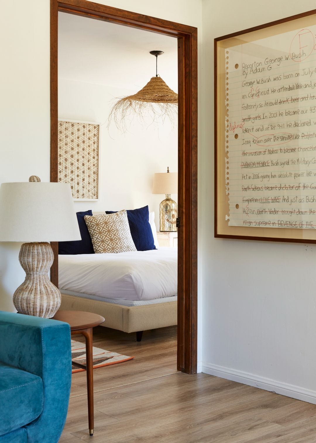 View through to the second bedroom in the Cottage at ESCAPE — woven pendant, rattan throw cushion