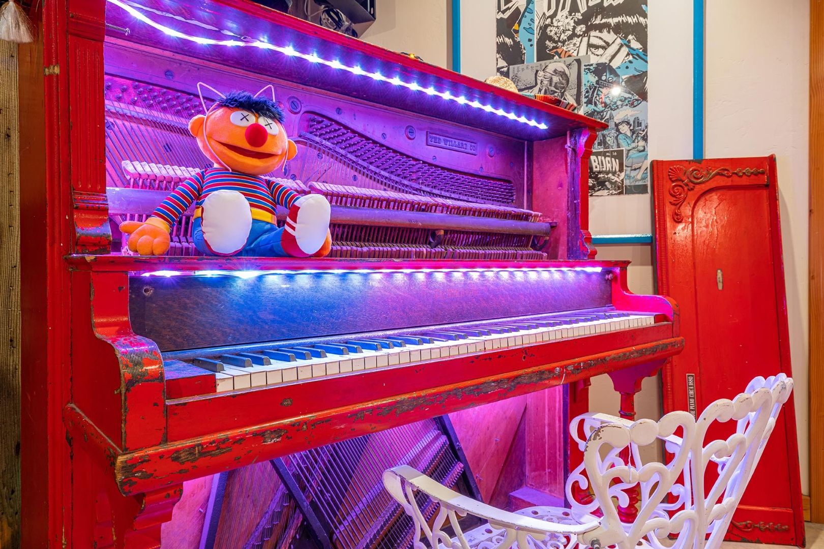 Lit red piano at The Goat at ESCAPE