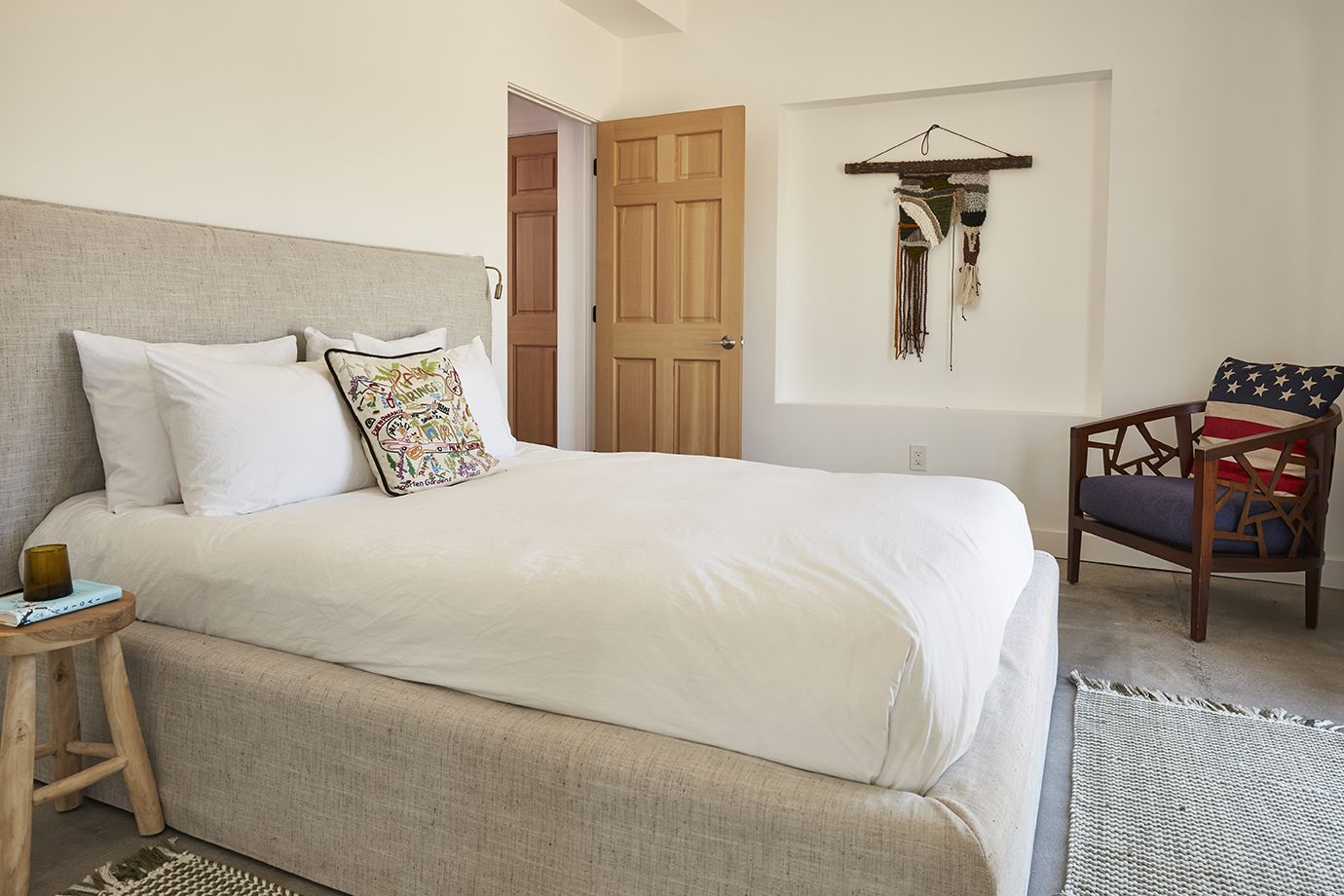 Lodge bedroom with linen headboard and American flag chair