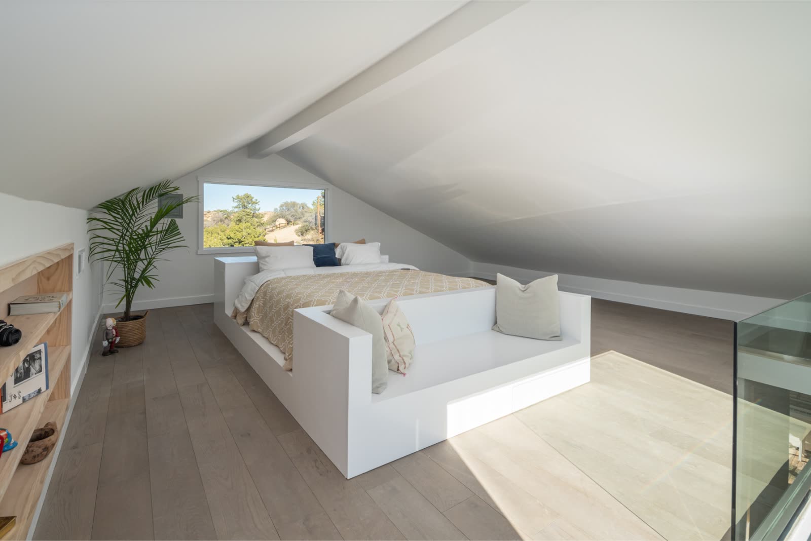 Lodge loft bedroom under vaulted white ceiling