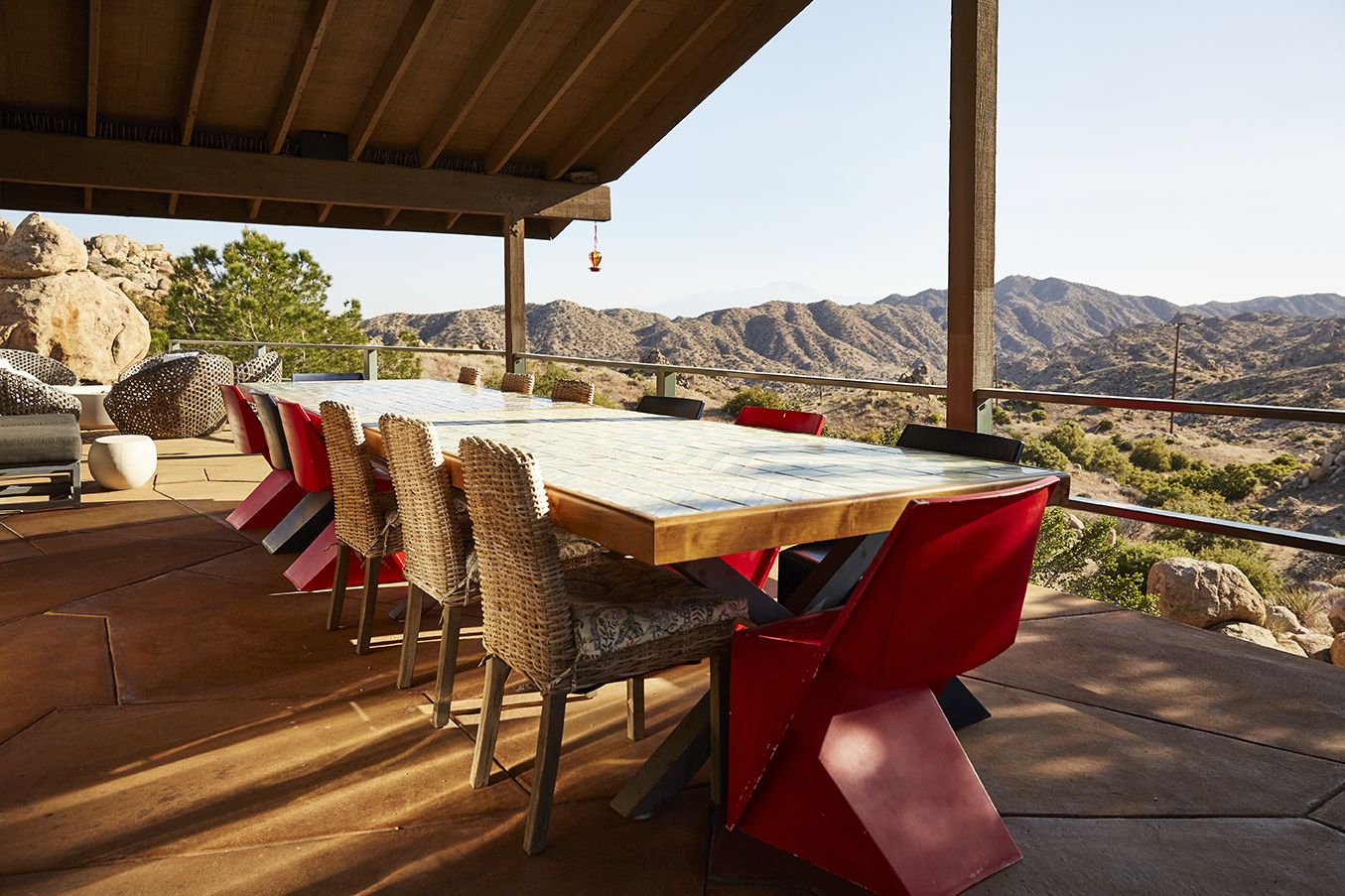 The dinner table at the Main House at ESCAPE — desert mountains beyond, set for retreat groups