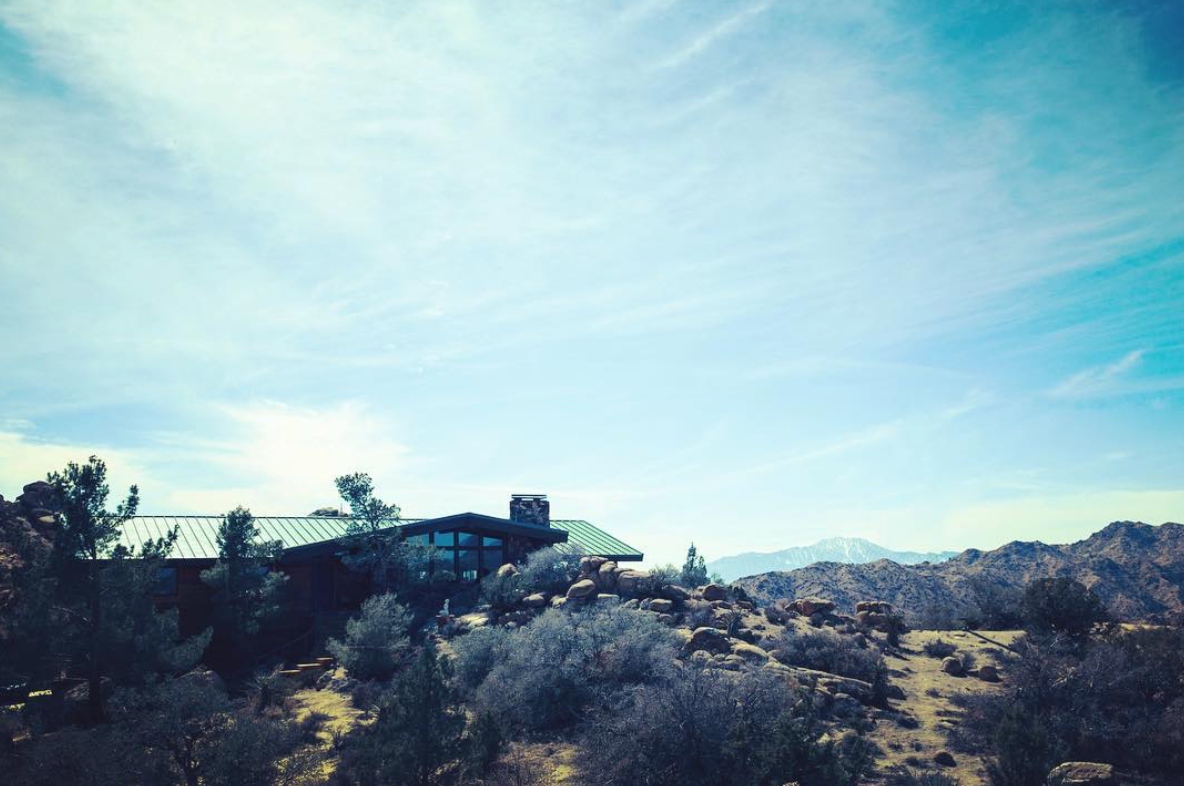 Main House from a distance, framed by the desert