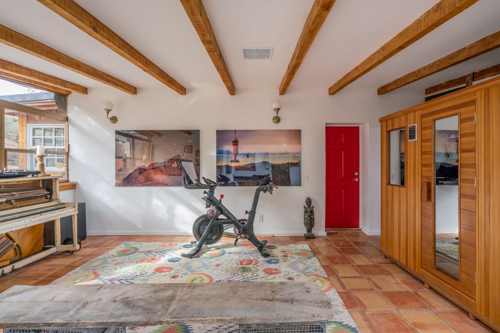 The wellness area at ESCAPE with a Peloton and sauna under a vaulted wood ceiling — used by athletes training at 4,200 feet altitude